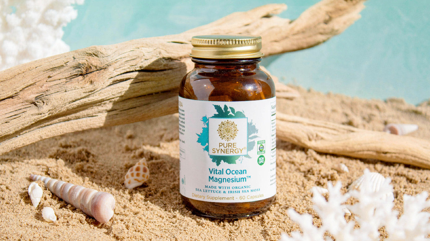 A bottle of Vital Ocean Magnesium on a beach scene