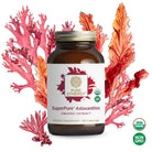 The Synergy Company's SuperPure® Astaxanthin Extract comes in a bottle of 60 capsules, certified USDA Organic and Non-GMO. The packaging features illustrated red seaweed, emphasizing its origins from Haematococcus pluvialis algae and highlighting its rich antioxidant properties.