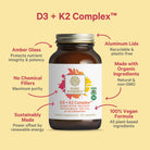 A bottle of The Synergy Company D3 + K2 Complex™ is shown with arrows highlighting features: amber glass, no chemical fillers, sustainable production, aluminum lids, organic ingredients, and a 100% vegan formula.