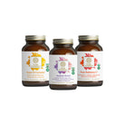 Three brown supplement bottles from The Synergy Company’s Mood & Stress Balance Bundle stand side by side, each with a colorful leaf label emphasizing support for stress balance and well-being.