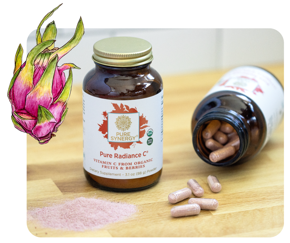 Two bottles of Pure Synergy Pure Radiance C capsules, some capsules and powder on a wooden surface, with a dragon fruit illustration on the left.