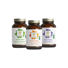 Three bottles of supplements from The Synergy Company are displayed. From left to right: Matcha Power, a vibrant green matcha capsule loaded with adaptogens; Vita·Min·Vitality, an orange men's multivitamin; and Stress Remedy with a calming purple label. Together, these products make up the Working Man Bundle.