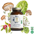 A bottle of The Synergy Company's Zinc Complex™ dietary supplement is adorned with illustrations of organic vegetables, fruits, and mushrooms. Featuring organic mushroom mycelia and offering immune support benefits, this certified organic and non-GMO product contains 60 capsules.